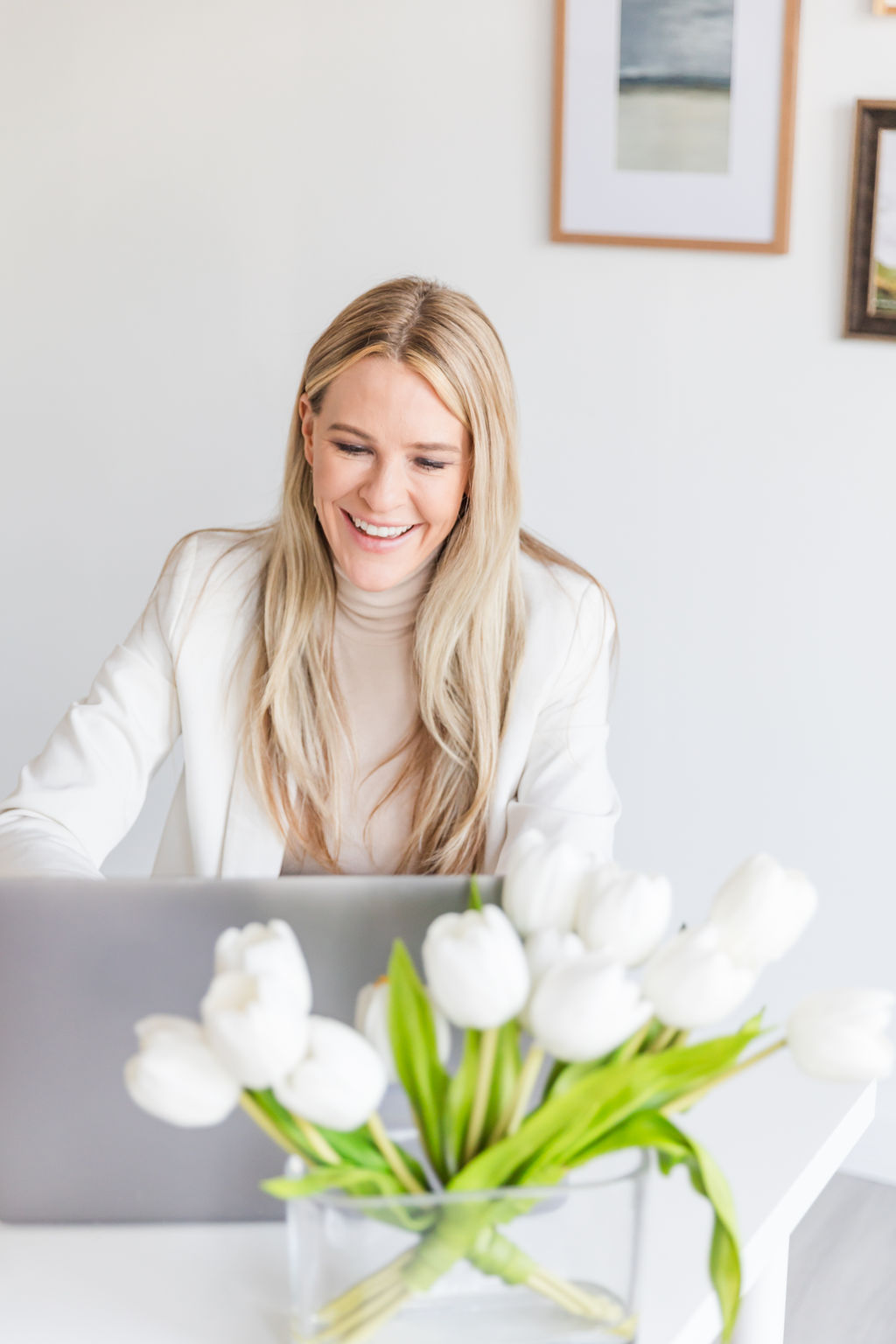 Chelsea Cadwell of Intoto Recruiting working at her computer and smiling